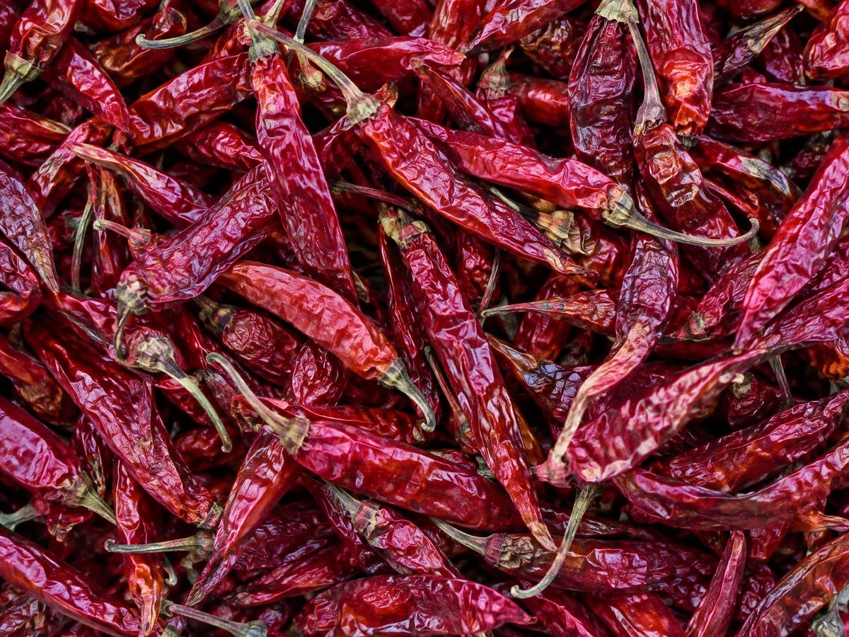 Whole dried red chillies with stems, heaped