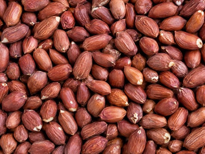 Red-skinned groundnut kernels filling the frame